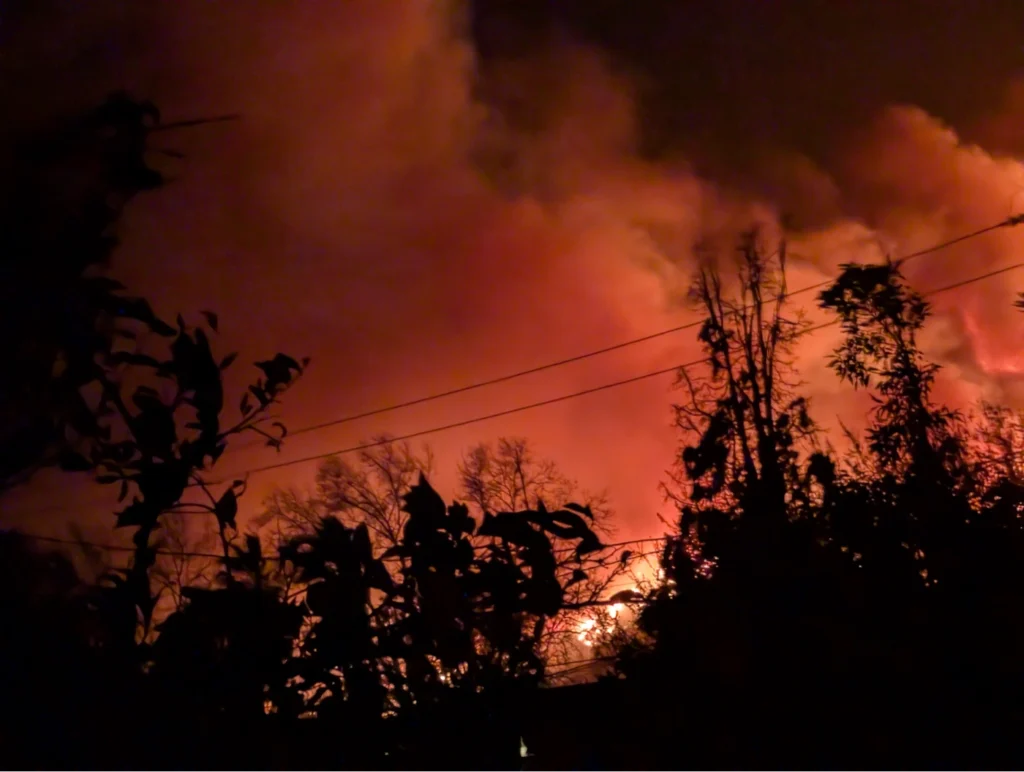 a picture of the eaton fire raging over the ridge from where I live